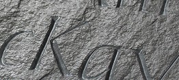 Incised letters on riven slate